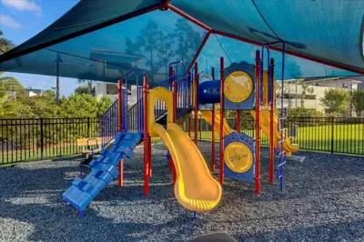 a playground with a slide in a park at Near Universal's Epic Universe Suite -3BR in Orlando