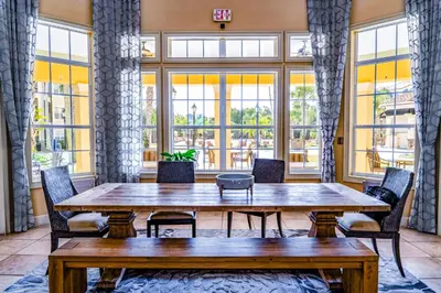 a large room with a wooden table and chairs at WorldQuest Orlando Resort in Orlando