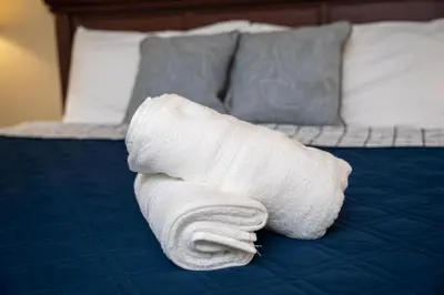 a roll of white towel on a bed at WorldQuest Orlando Resort in Orlando