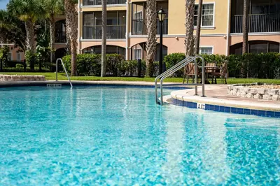 a swimming pool in front of a building at WorldQuest Orlando Resort in Orlando