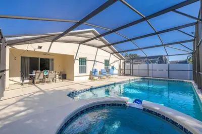 a swimming pool with a glass roof over a patio at Single Story Villa with Pool Views and Family Fun in Orlando
