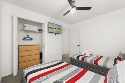 a bedroom with two beds and a ceiling fan at Single Story Villa with Pool Views and Family Fun in Orlando