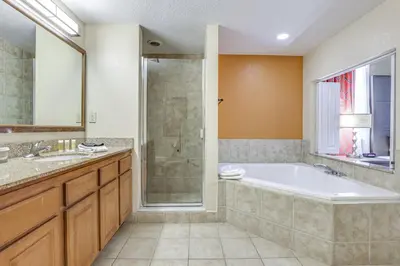 a large bathroom with a tub and a shower at Poolside Oasis 7 Mi to Disney and Universal in Orlando