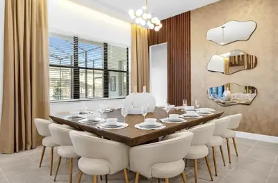 a dining room with a long table and white chairs at Epic Paradiso Mansion-Pool,Game Room,Theater-4 in Orlando