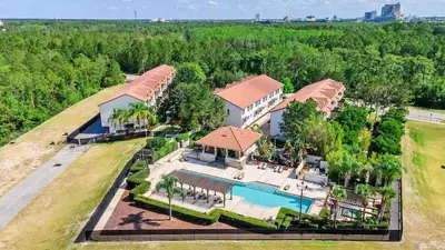 an aerial view of a mansion with a swimming pool at Sunny Summer Magic - Stay in TownHome by Disney in Orlando