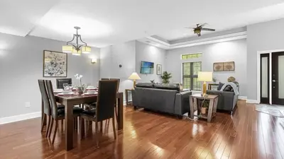 a living room with a table and a couch at Sunny Summer Magic - Stay in TownHome by Disney in Orlando