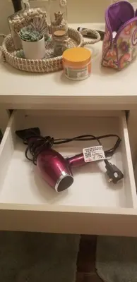 a shelf with a hair dryer on a table at Cozy 2 bedroom Orlando apartment in Orlando