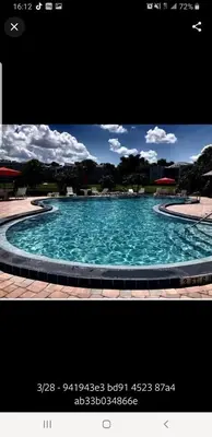 a large swimming pool with blue water at Cozy 2 bedroom Orlando apartment in Orlando