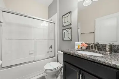 a bathroom with a shower and a toilet and a sink at Luxe Lakeview Private Pool SPA 10 Min Disney in Kissimmee