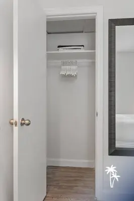 a room with a closet with a mirror at Lake View Top Floor 2 Bed 2 Bath Condo with Balcony in Orlando