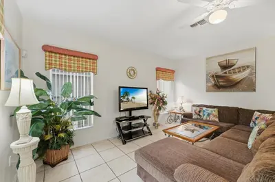 a living room with a couch and a tv at Near Disney Pool Hot Tub Stunning Water View in Kissimmee