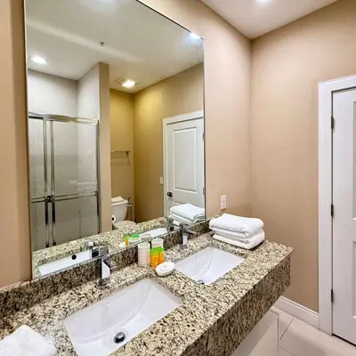 a bathroom with a sink and a large mirror at Spacious 4-Suite Villa with Balcony, Magic Village in Orlando