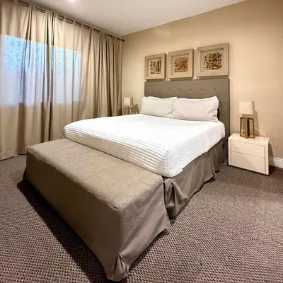 a bedroom with a large white bed and a window at Spacious 4-Suite Villa with Balcony, Magic Village in Orlando