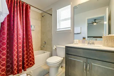 a bathroom with a toilet and a sink and a shower at Pool Access Family Gem with Views in St Cloud! in Saint Cloud