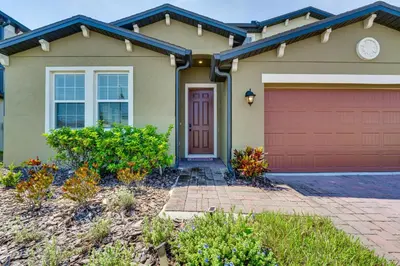 a house with a red garage at Pool Access Family Gem with Views in St Cloud! in Saint Cloud