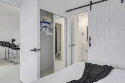 a bedroom with a white door and a mirror at Luxury Private Apt at Disney Area in Orlando
