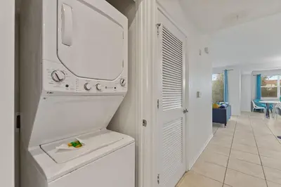 a kitchen with a washer and dryer at Sunset Retreat at Storey Lake Resort by Shine Villas condo in Kissimmee