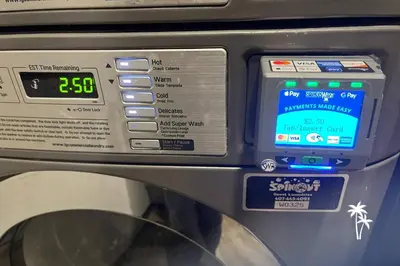 a machine with a clock on the side of it at Delightful Studio Condo with Garden View Balcony 7 Mins to Universal in Orlando