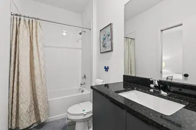 a bathroom with a sink and a toilet and a shower at Modern Townhome 10min to Disney in Kissimmee