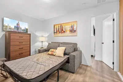 a bedroom with a bed and a couch at Modern Townhome 10min to Disney in Kissimmee