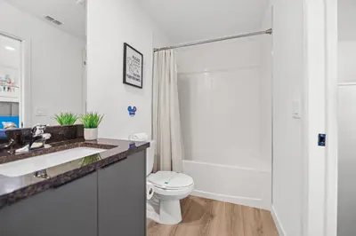 a bathroom with a toilet and a sink and a shower at Modern Townhome 10min to Disney in Kissimmee