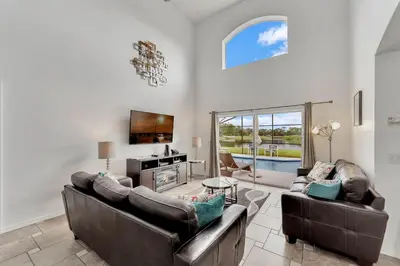a living room with two couches and a tv at Casa Vista Lago c/ Piscina Privada – Próx. Disney in Kissimmee