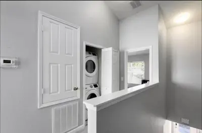 a laundry room with a door and a washing machine at Relaxing vacation resort villa in Orlando