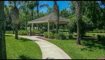 a gazebo in a park with palm trees at Relaxing vacation resort villa in Orlando