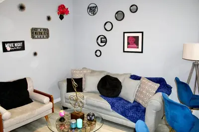 a living room with a couch and a table at Level Up Your Vacation Stylish Home Near Disney in Kissimmee