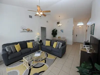 a living room with a couch and a table at Holiday Hideout by Paradise Resort Vacations in Orlando