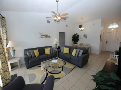 a living room with a couch and a table at Holiday Hideout by Paradise Resort Vacations in Orlando