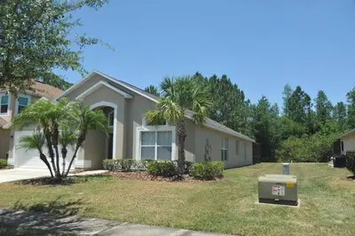 a house with a palm tree in the yard at Sunshine Serenity by Paradise Resort Vacations in Kissimmee