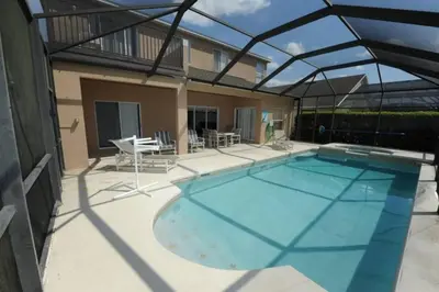 a large swimming pool with a roof at Tranquil Waters Haven by Paradise Resort Vacations in Kissimmee