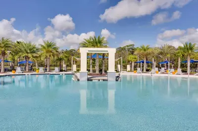 a large pool with palm trees and a gazebo at UPSTAY- 10BR Mansion wPrivate Pool and Games Room in Kissimmee