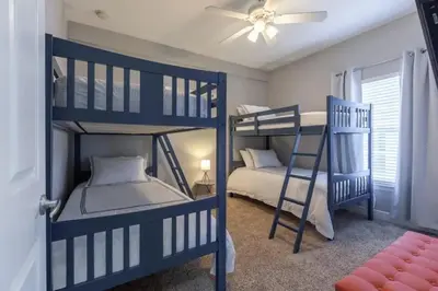 a bedroom with two bunk beds and a ceiling fan at 4 Bedrooms 3 Bathrooms Lucaya Village 2-101 in Kissimmee