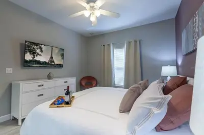 a bedroom with a white bed and a ceiling fan at 4 Bedrooms 3 Bathrooms Lucaya Village 2-101 in Kissimmee