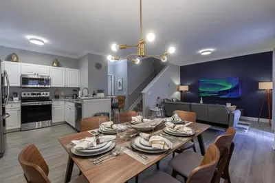 a dining room and kitchen with a table and chairs at 4 Bedrooms 3 Bathrooms Lucaya Village 2-101 in Kissimmee