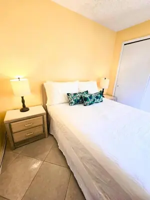a bedroom with a bed and a nightstand with a lamp at Retro 3 Bedroom Economy Family Home with washer and dryer in unit in Kissimmee