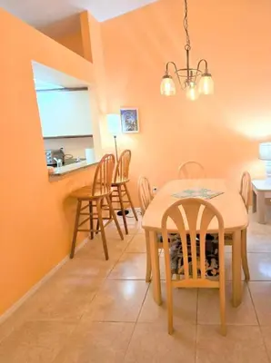 a kitchen and dining room with a table and chairs at Retro 3 Bedroom Economy Family Home with washer and dryer in unit in Kissimmee