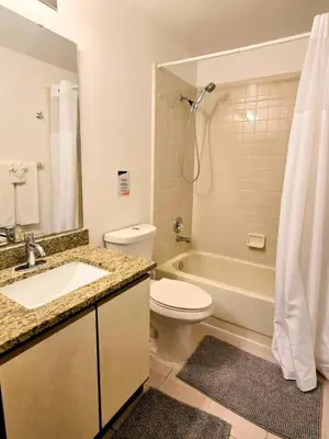 a bathroom with a toilet and a sink and a shower at Retro 3 Bedroom Economy Family Home with washer and dryer in unit in Kissimmee