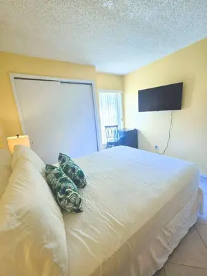 a bedroom with a white bed with two pillows on it at Retro 3 Bedroom Economy Family Home with washer and dryer in unit in Kissimmee