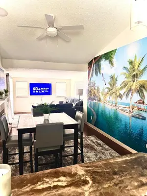 a dining room with a table and a view of the ocean at Tropical Paradise in Orlando