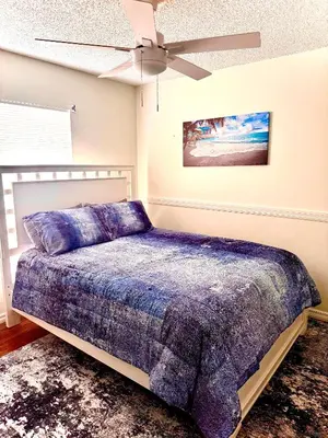 a bedroom with a bed and a ceiling fan at Tropical Paradise in Orlando