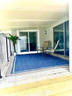a patio with a table and chairs on a porch at Tropical Paradise in Orlando
