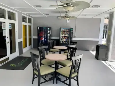 a dining room with tables and chairs and a fan at Two bed condo in Parkway Palms Resort in Orlando