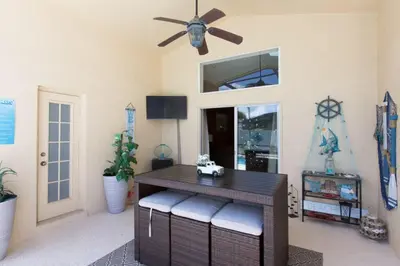 a dining room with a table and a ceiling fan at Indian Creek Vacation Home Close to Disney in Orlando
