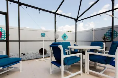a room with blue chairs and a table on a roof at Indian Creek Vacation Home Close to Disney in Orlando