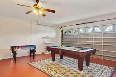 a room with a pool table and a ceiling fan at Indian Creek Vacation Home Close to Disney in Orlando