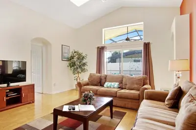 a living room with a couch and a table at Indian Creek Vacation Home Close to Disney in Orlando