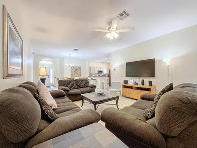 a living room with a couch and a flat screen tv at Walk to Silver Spurs Rodeo and Heritage Park in Kissimmee